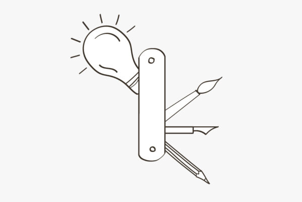 An image of a lightbulb and some other organizational tools on a blog about the benefits of marketing outsourcing