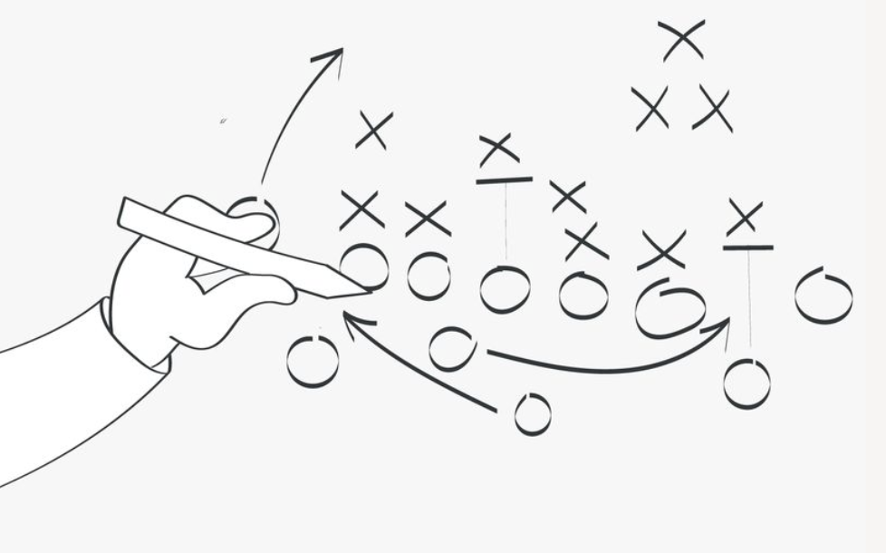Hand drawing a strategic play diagram with X’s and O’s — symbolizing a marketing plan during a downturn