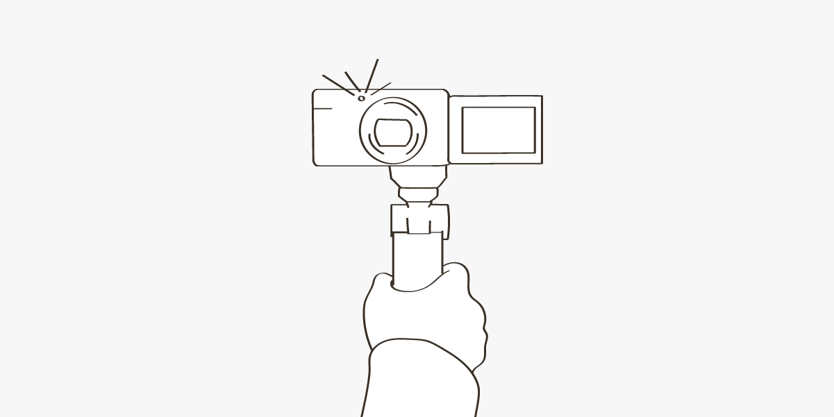 An illustration of a hand holding a video camera on a blog about vlogging