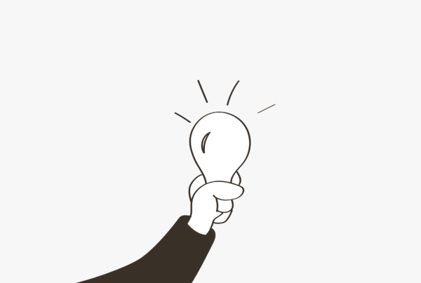 A drawing of a hand holding a light bulb on a blog about 2024 marketing planning